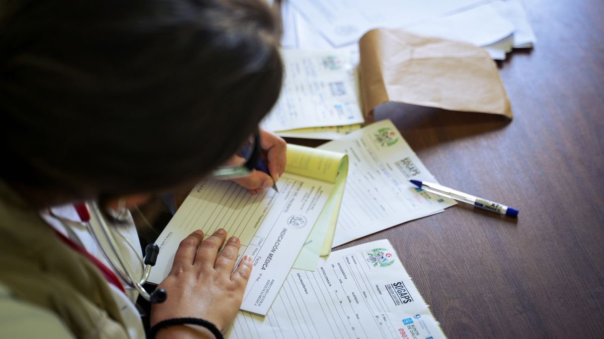 Service member organizing medical records and separation paperwork at a desk