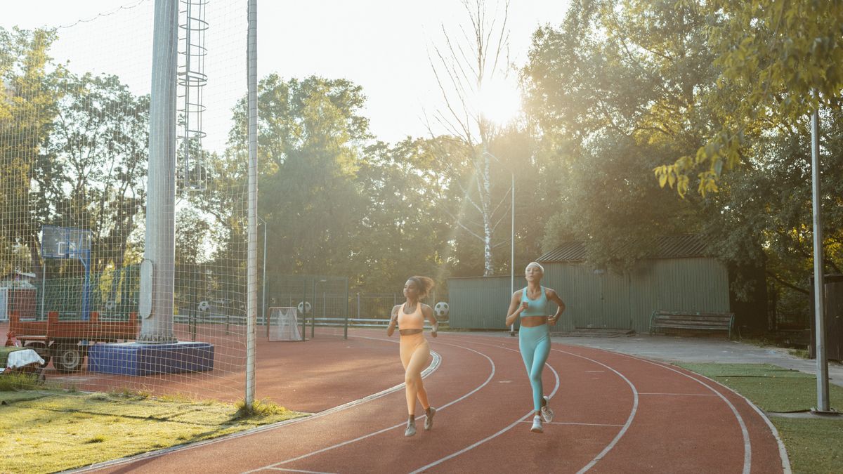 Prospective military recruit timing an easy run on an outdoor track