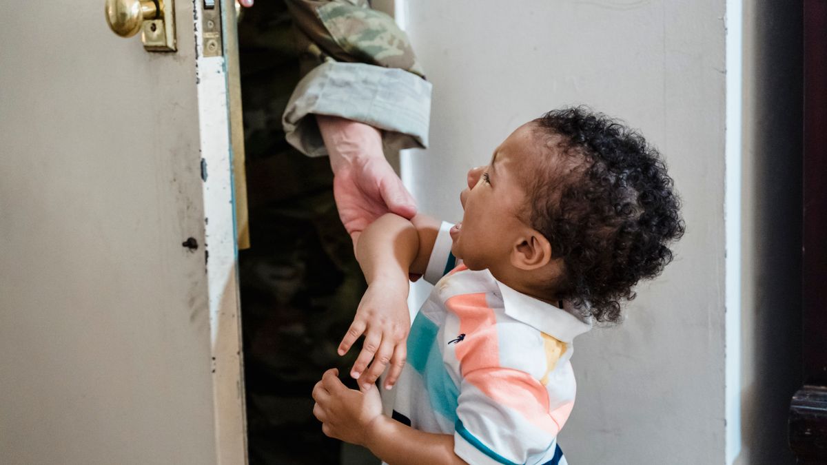 Military family packing boxes before leaving a home