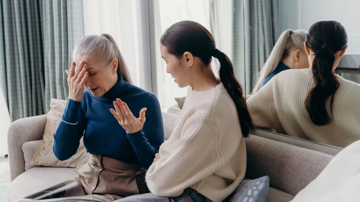 Parent resting while a caregiver assists a child at home