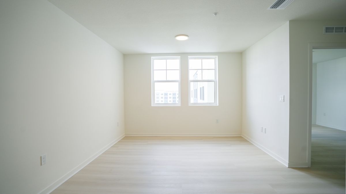 Service member comparing apartment listings at a kitchen table