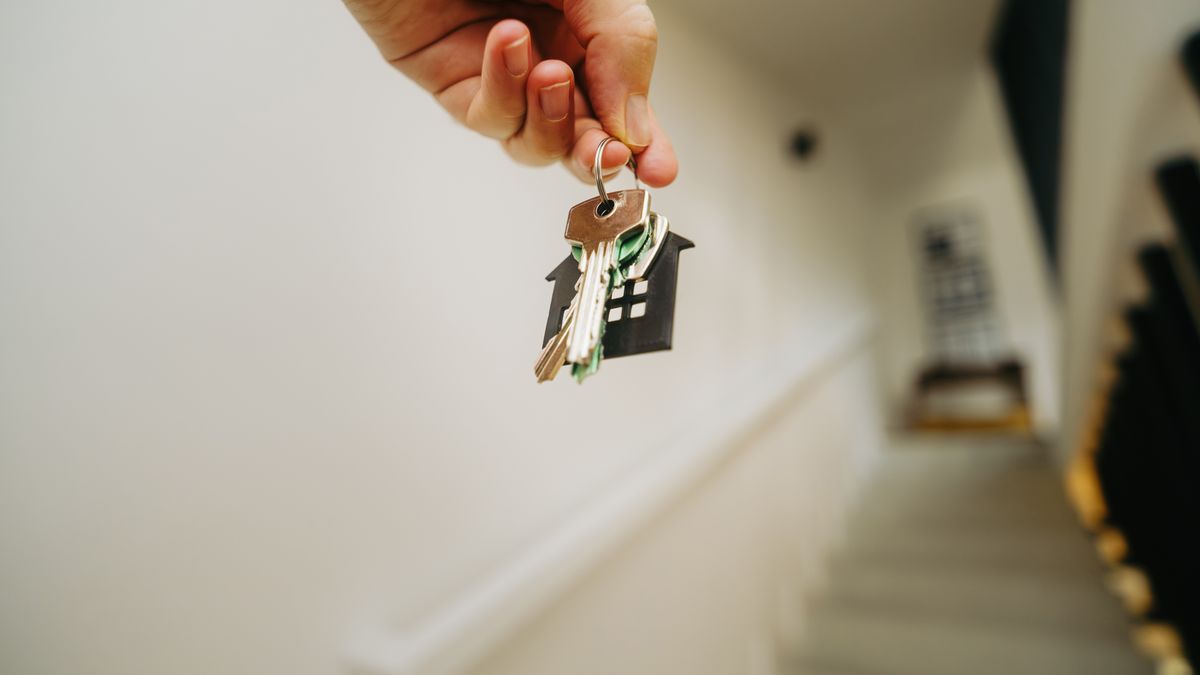 Uniformed service member receiving keys to an overseas apartment
