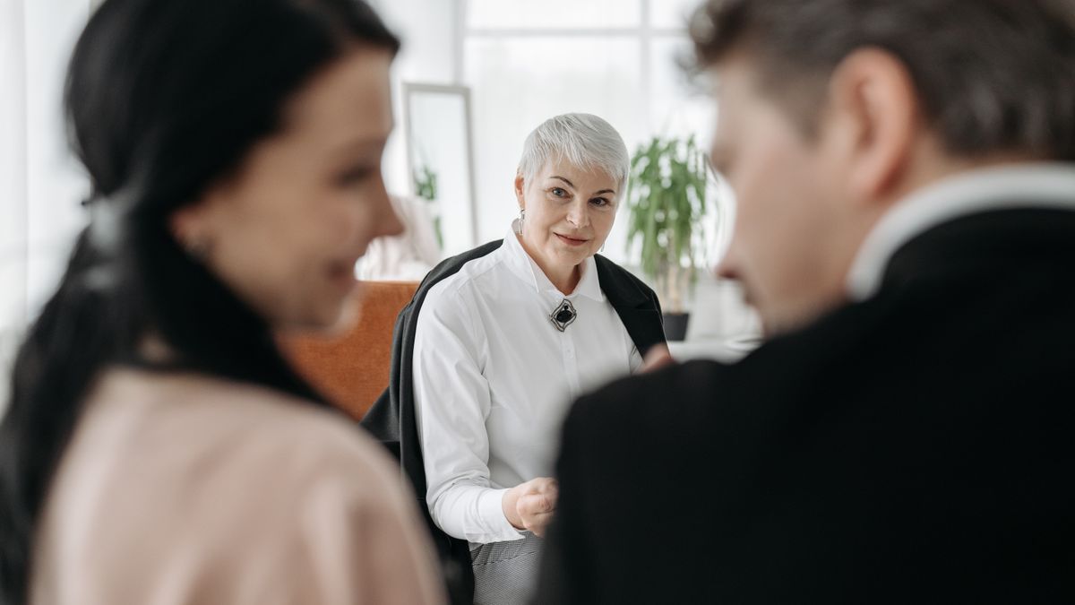 Service member and spouse meeting with a financial counselor in an office
