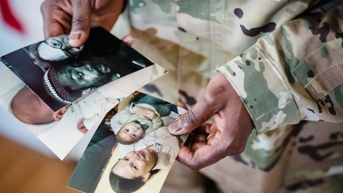 Service member reviewing a military leave and earnings statement at a desk
