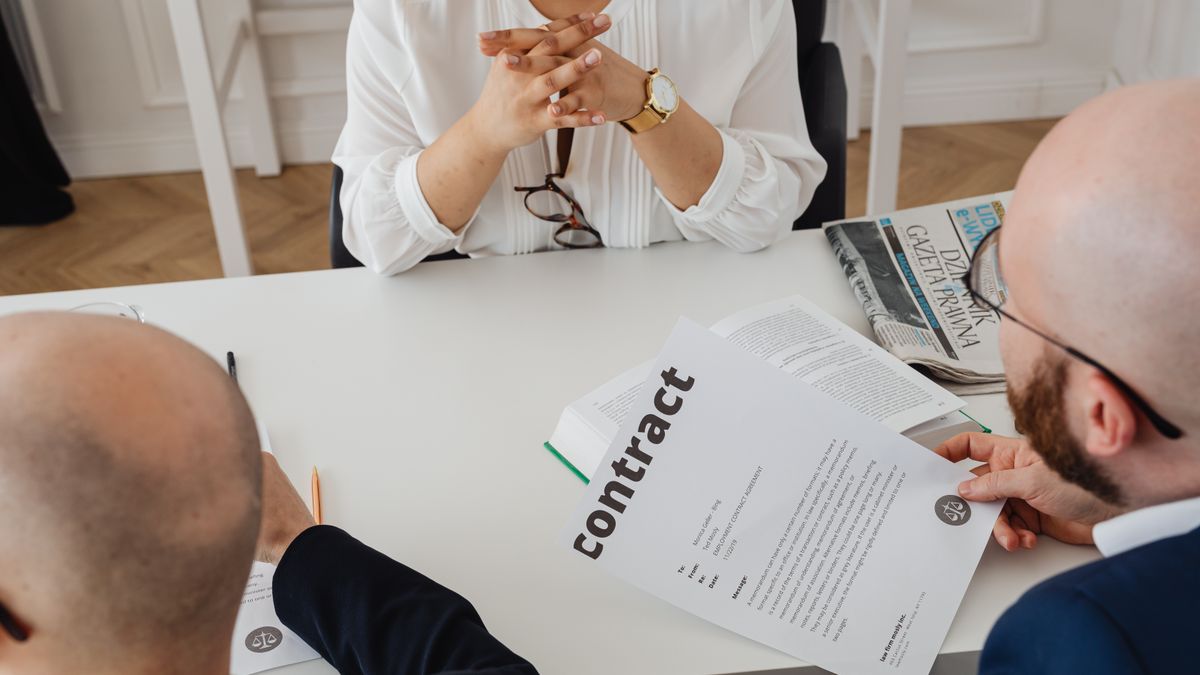 Transitioning service member discussing a civilian job offer across a conference table