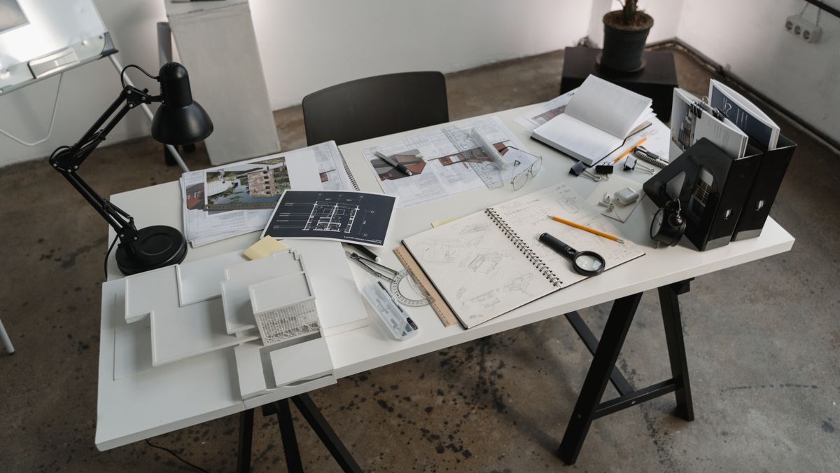 Service member organizing a résumé, financial worksheet, and separation documents at a desk