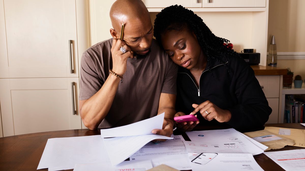 Active-duty couple reviewing a household budget and TSP contribution plan