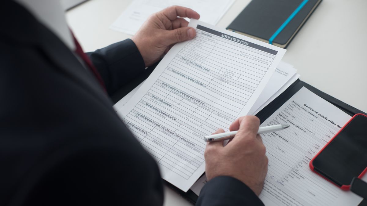 Prospective recruit reviewing enlistment paperwork at a desk