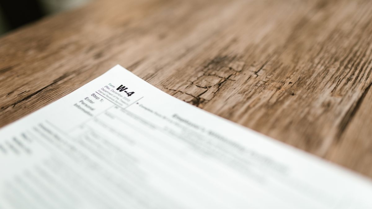 Service member reviewing military pay records and retirement paperwork at a desk