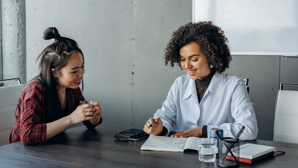 Service member comparing education benefit paperwork with a college adviser