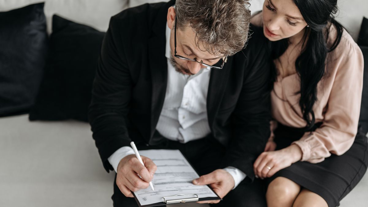 Military couple reviewing legal and financial documents before deployment