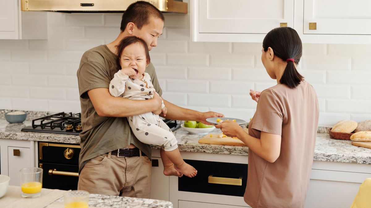 Military spouse organizing a family calendar at the kitchen table