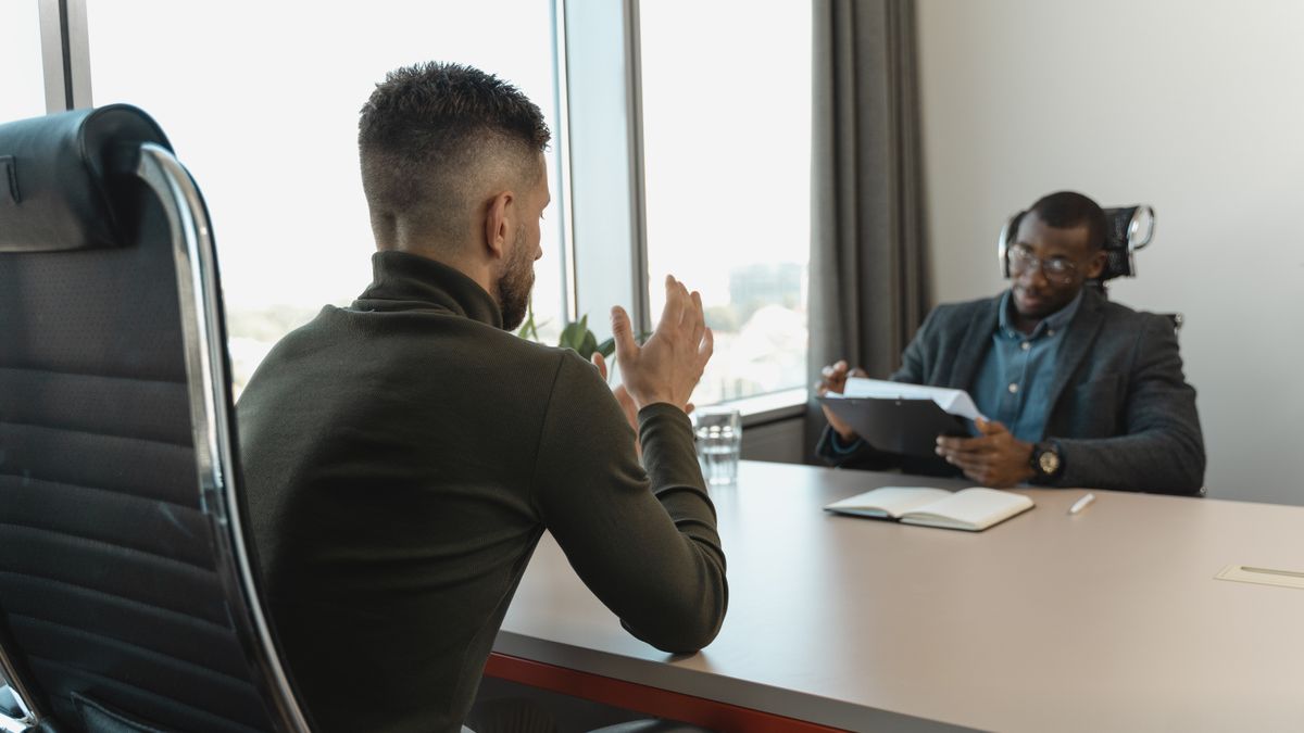 Service member in civilian clothes attending an office job interview