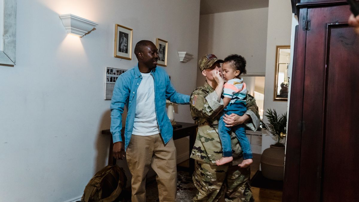 Military family reviewing education benefit information on a laptop