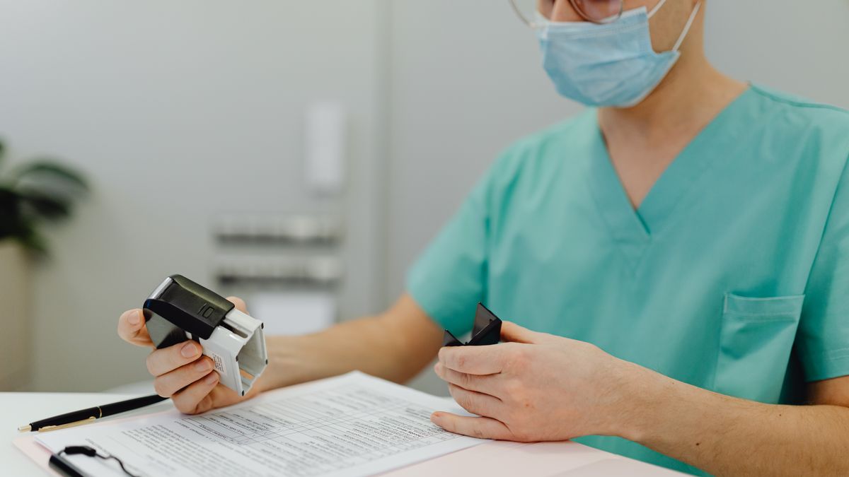 Reserve family comparing health insurance paperwork at a kitchen table