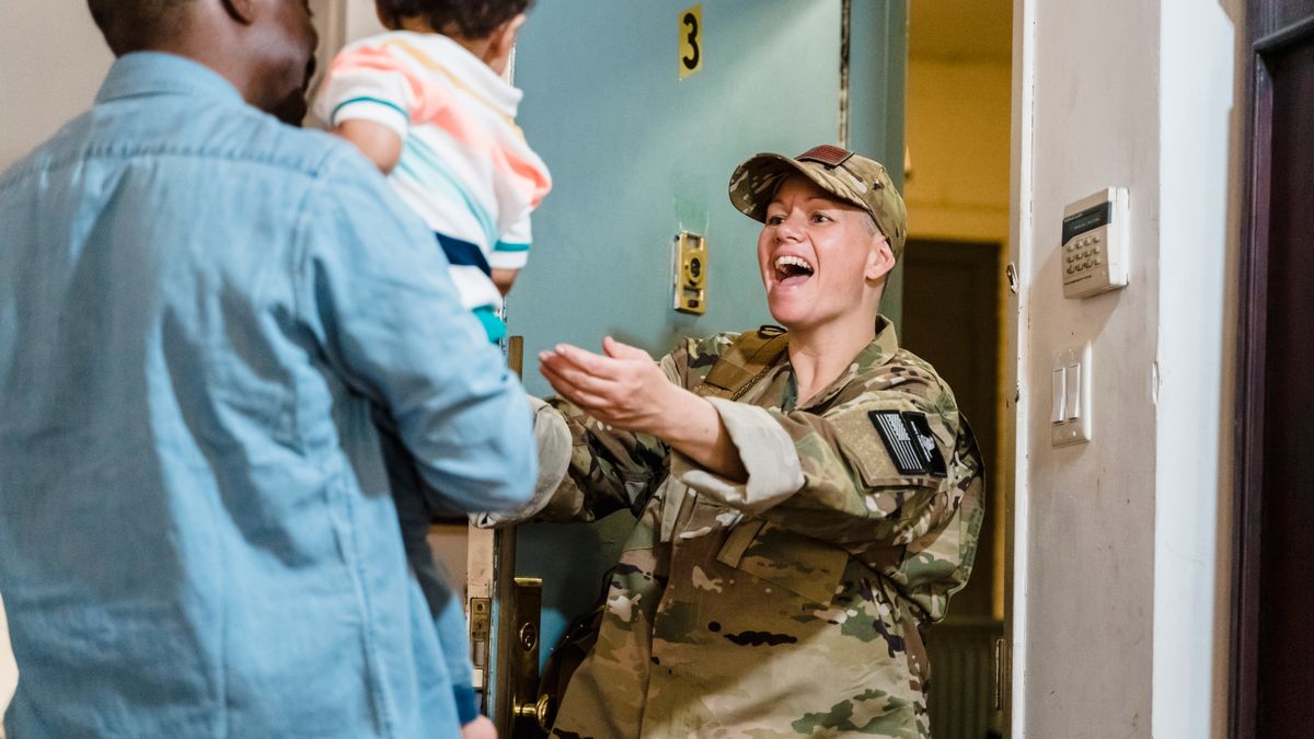 Reserve service member returning to a civilian office with a work bag