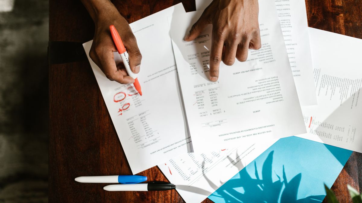 Guard member reviewing health insurance paperwork at a kitchen table