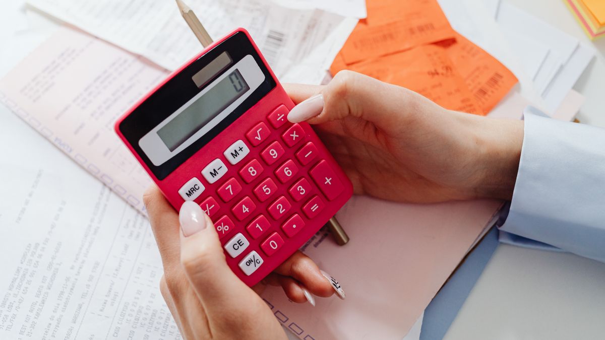 Veteran checking disability percentages with a calculator and paperwork