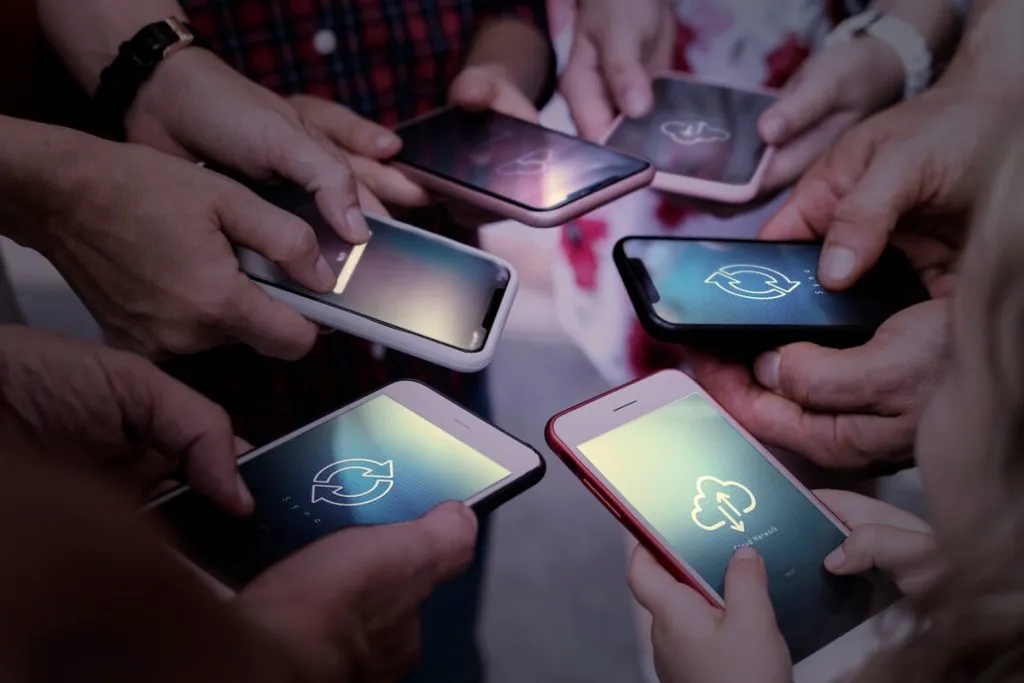 Several people holding smartphones displaying data usage icons