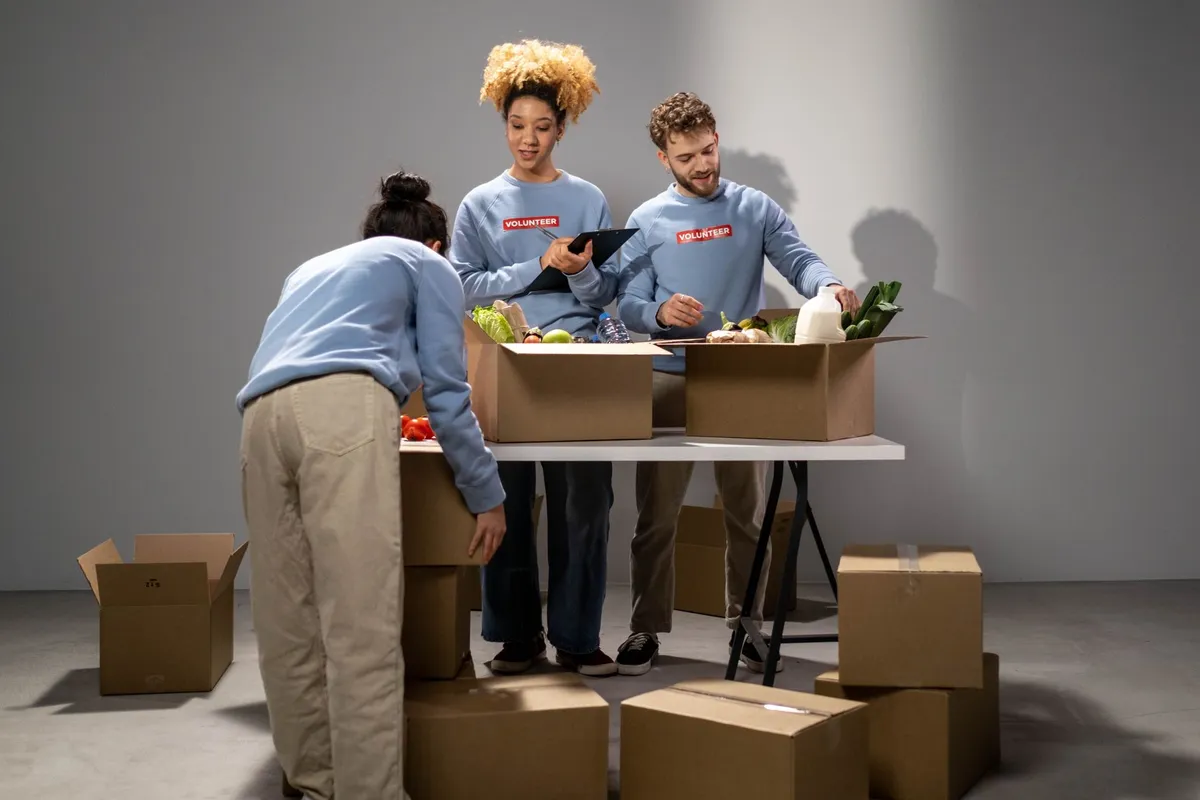 Volunteers packing boxes of groceries at a community food bank